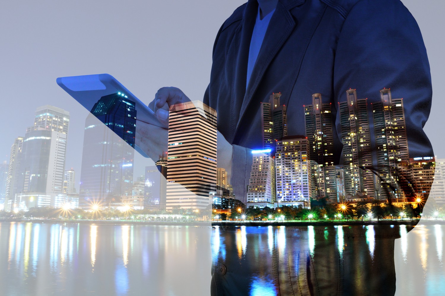 Double,Exposure,Of,Night,City,And,Business,Man,Using,Digital